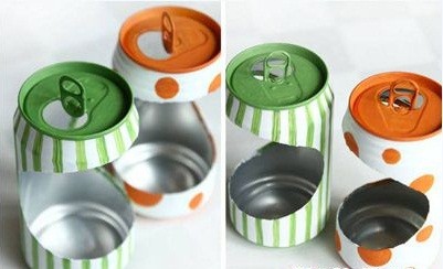 Nhiều vỏ lon đã được sơn và trang trí đang được đặt chờ khô để làm chậu trồng cây lon